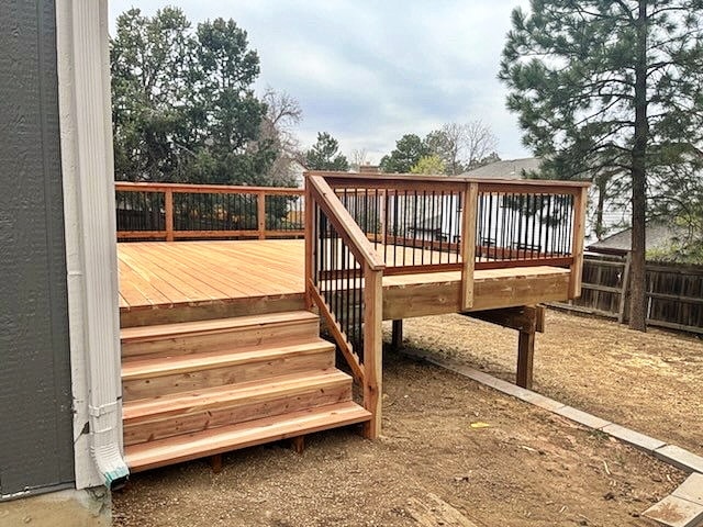 Newly built cedar deck with metal railing and stairs